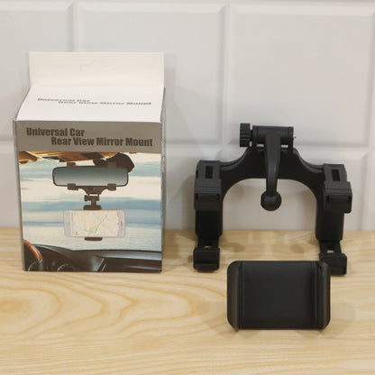 A black car phone mount disassembled next to its white product box on a wooden surface.
