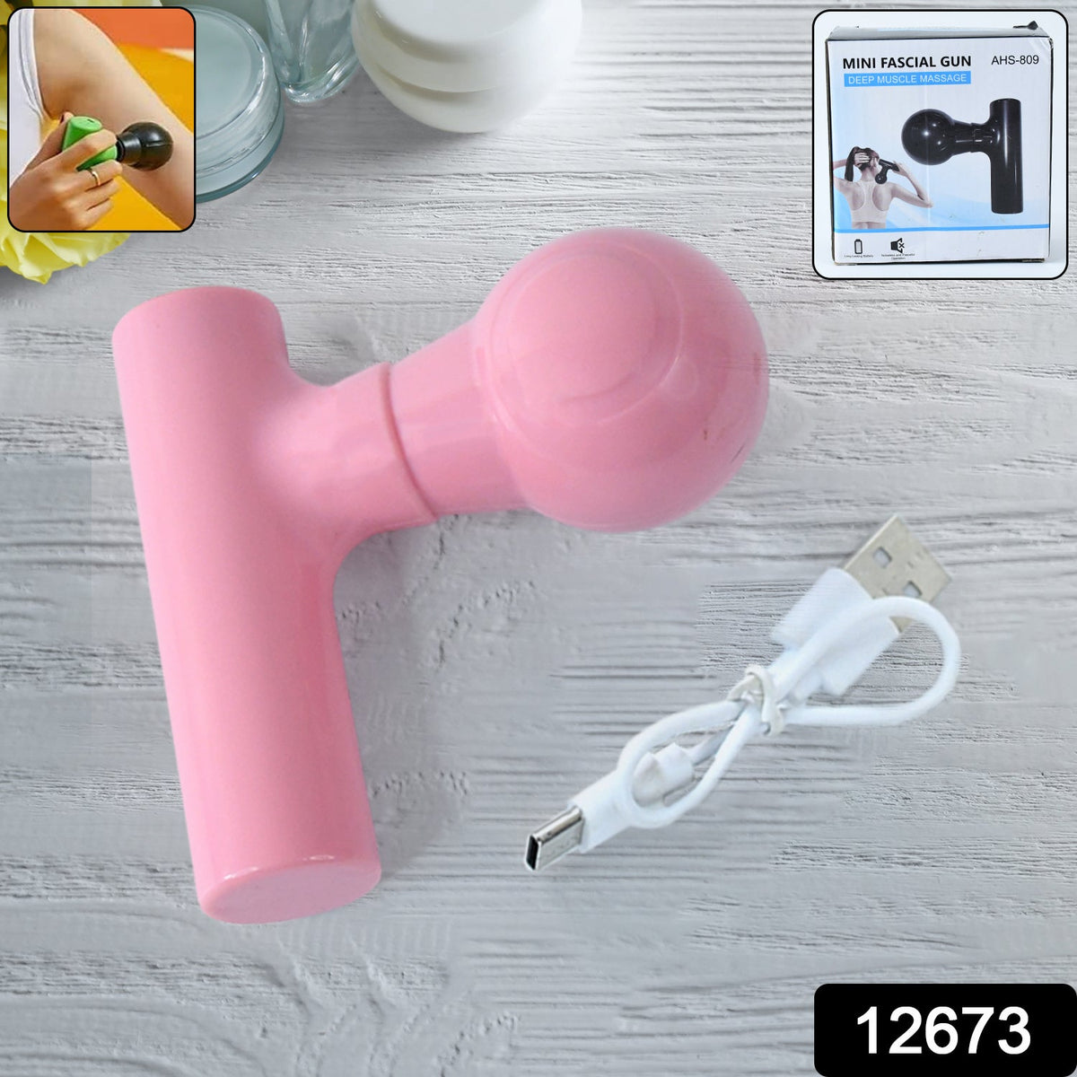 Black mini body massager shown with its charging cable, ideal for pain relief.