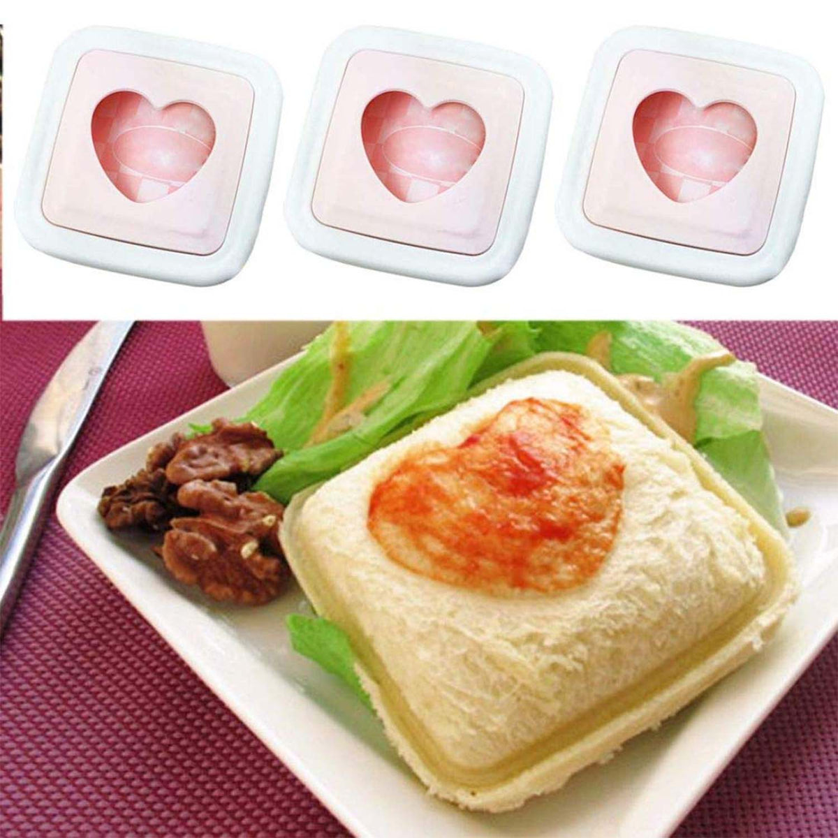 Three pink and white heart-shaped sandwich cutters and a sandwich with a heart-shaped topping on a plate.