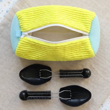 A yellow and blue shoe laundry bag with an open zipper, and two black shoe supports on a light brown fabric surface.