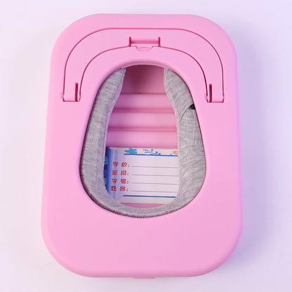 The pink desktop nap pillow is shown folded flat, revealing a gray cushion inside a rectangular opening.