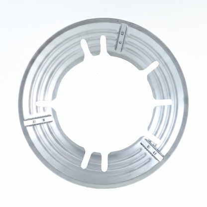 A top-down view of the circular silver gas stove trivet with six inner supports.