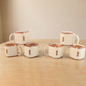 Close-up view of square tea cups showing modern design