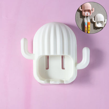 White cactus toothbrush holder on a light pink background, with a small inset showing other colors.