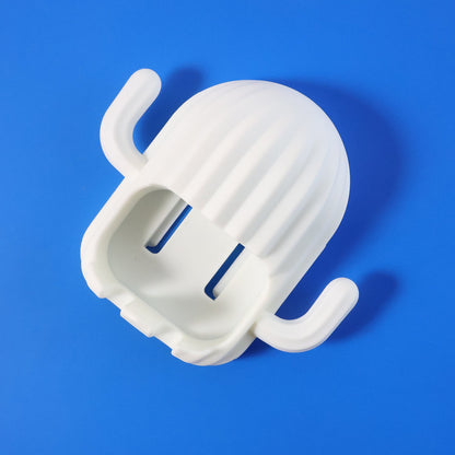 White cactus-shaped toothbrush holder with two slots, positioned diagonally on a vibrant blue background.