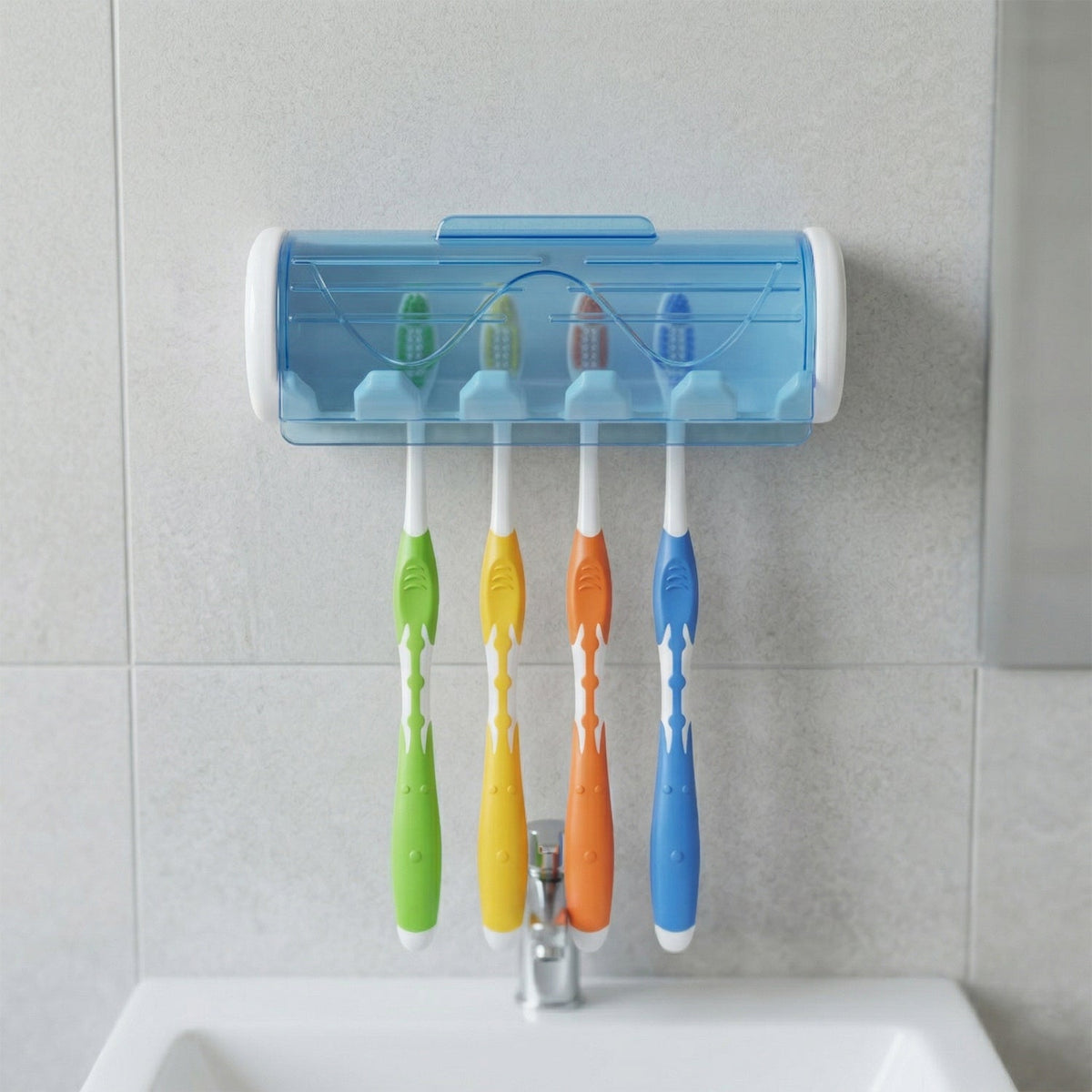 White and blue wall-mounted toothbrush holder with four colorful toothbrushes above a bathroom sink