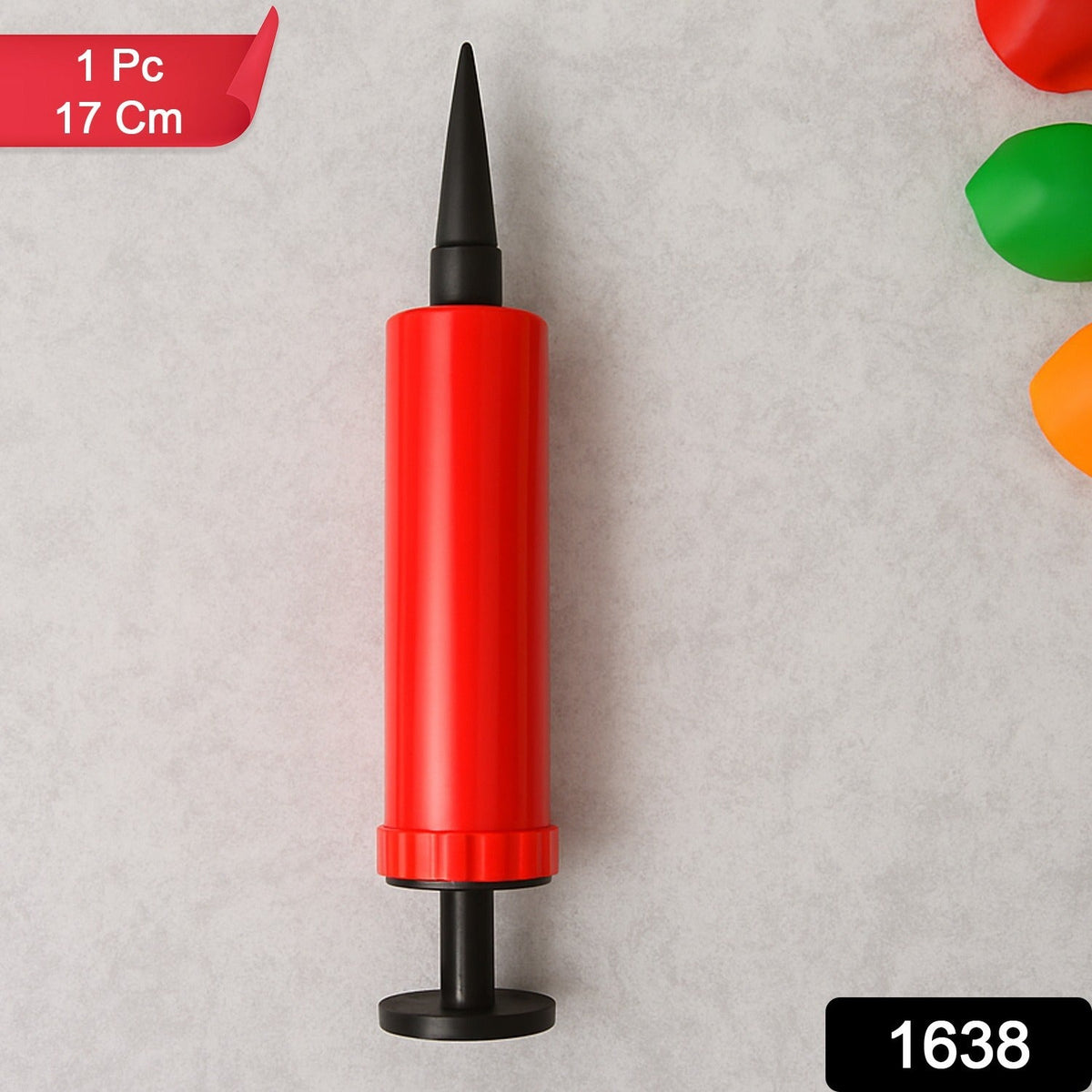 A red and black manual balloon pump stands upright against a light gray background, with a red label in the corner.