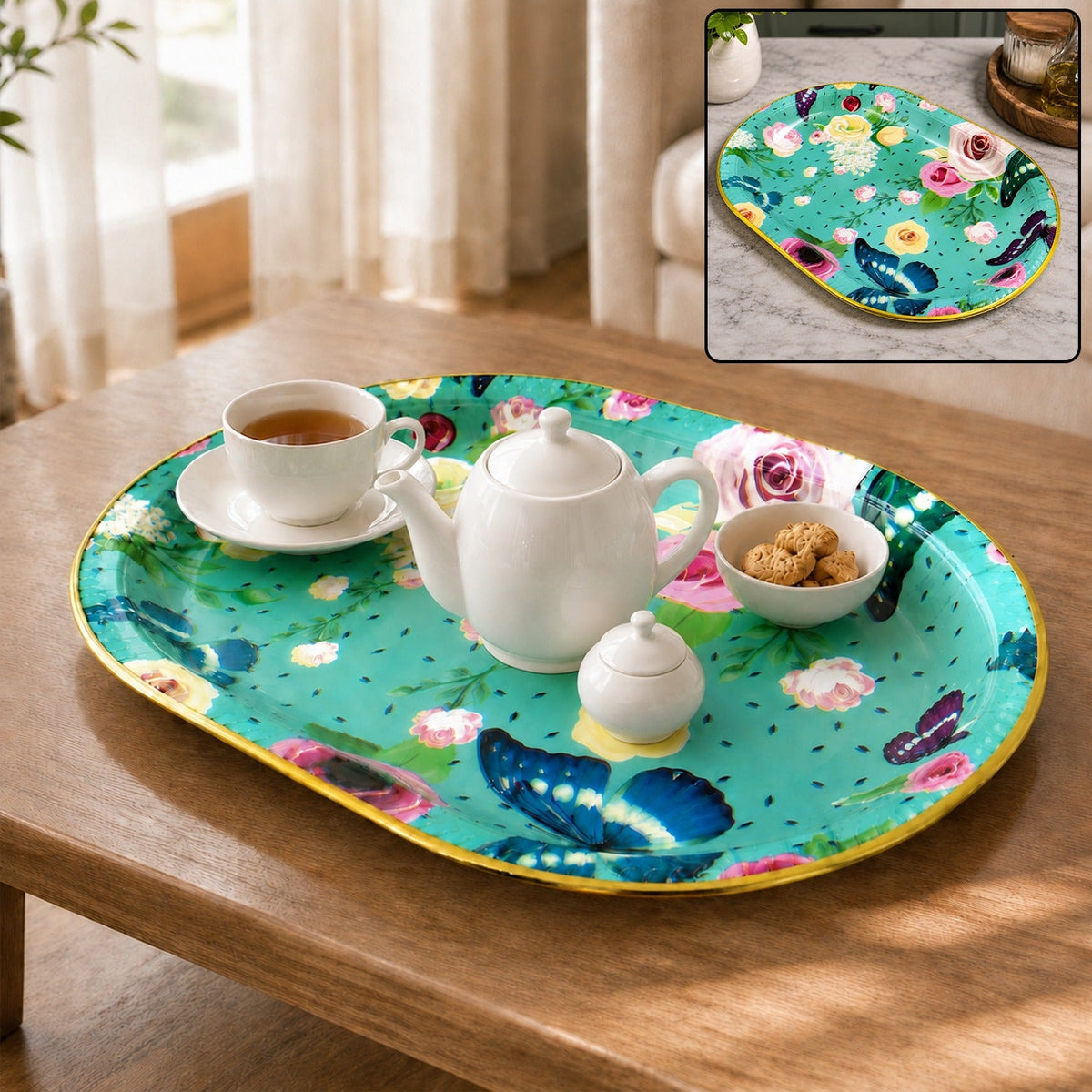 Oval turquoise tray with pink and yellow flowers, blue butterflies, holding a teapot, teacup, and cookies on a wooden table.