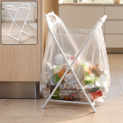 White plastic garbage bag holder with a clear bag full of trash, standing on a kitchen floor.