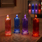 Four LED crystal candles in red, blue, purple, and orange, casting light patterns on a wooden surface.