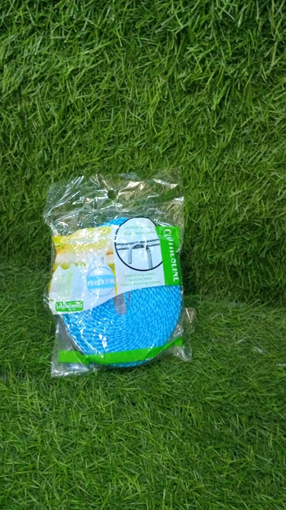 A packaged blue clothesline with product information is lying on a vibrant green artificial grass surface.