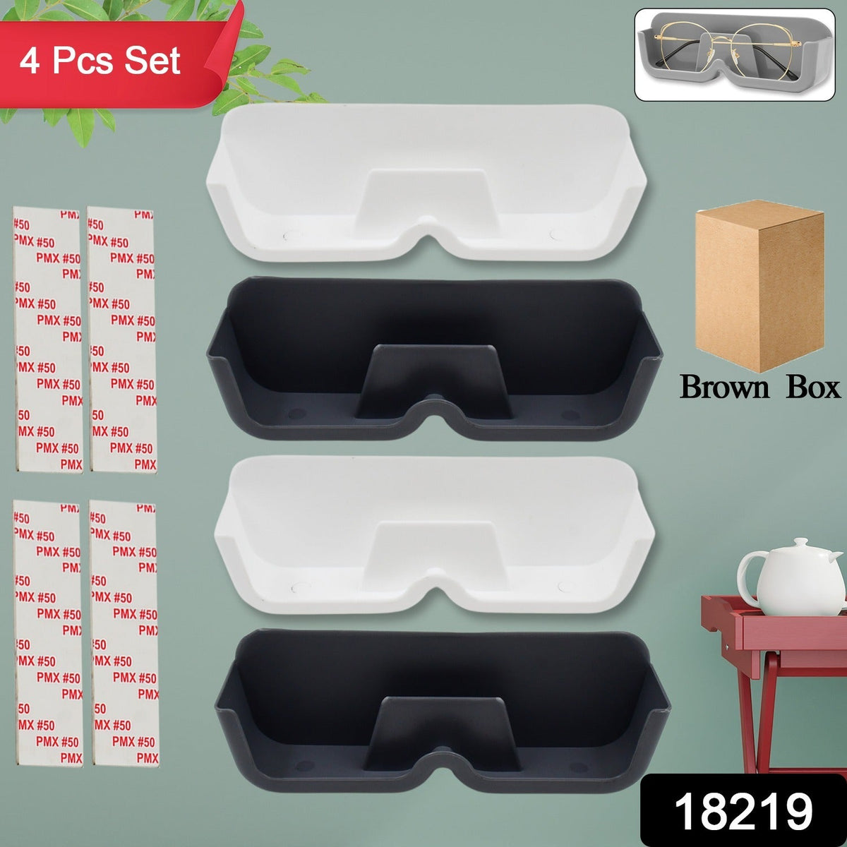 Four glasses holders, two white and two black, with adhesive strips and a brown box.