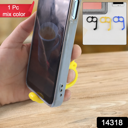 A hand holds a phone with a yellow finger ring phone holder supporting it from below.