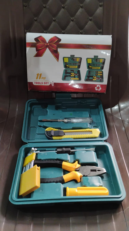 Open teal tool kit on a brown chair, displaying various yellow and black tools, with a gift box graphic on a white box