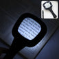 Black handheld magnifying glass with six LED lights illuminating text on an open book. Inset shows the magnifier and a pen.