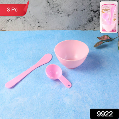 A pink mixing bowl, spatula, and measuring spoon are displayed on a blue surface with product packaging in the top right.