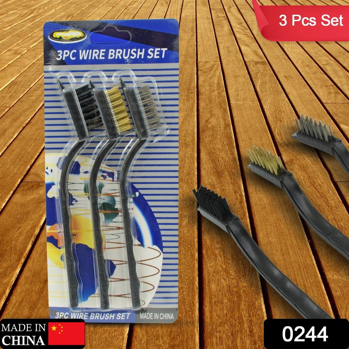 Three mini wire brushes in blister packaging on a wooden surface, with loose brushes to the right.
