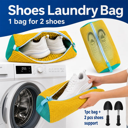 A yellow and blue shoe laundry bag with two white shoes inside, next to a washing machine and two black shoe supports.