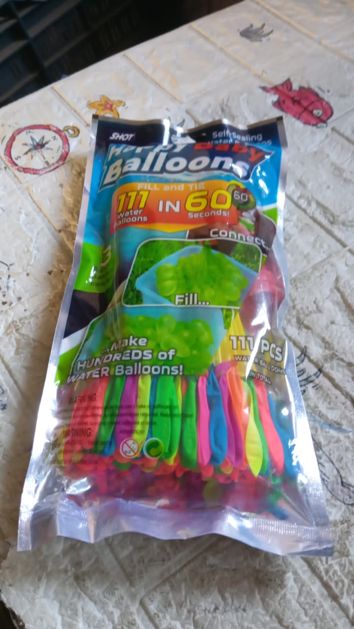 A stack of 111 multi-color self-tying water balloons packaging.