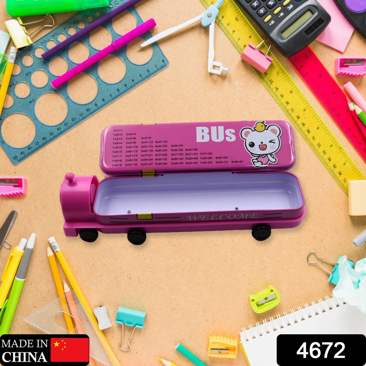 Open pink bus pencil case showing an empty compartment, surrounded by various school supplies on a wooden surface.