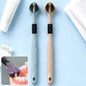 Two three-sided toothbrushes, one blue and one beige, with white toothpaste and dental floss in the background.