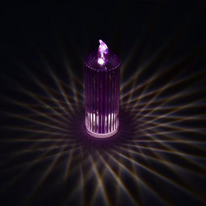 A single purple LED crystal candle casting intricate swirling light patterns on a dark surface.
