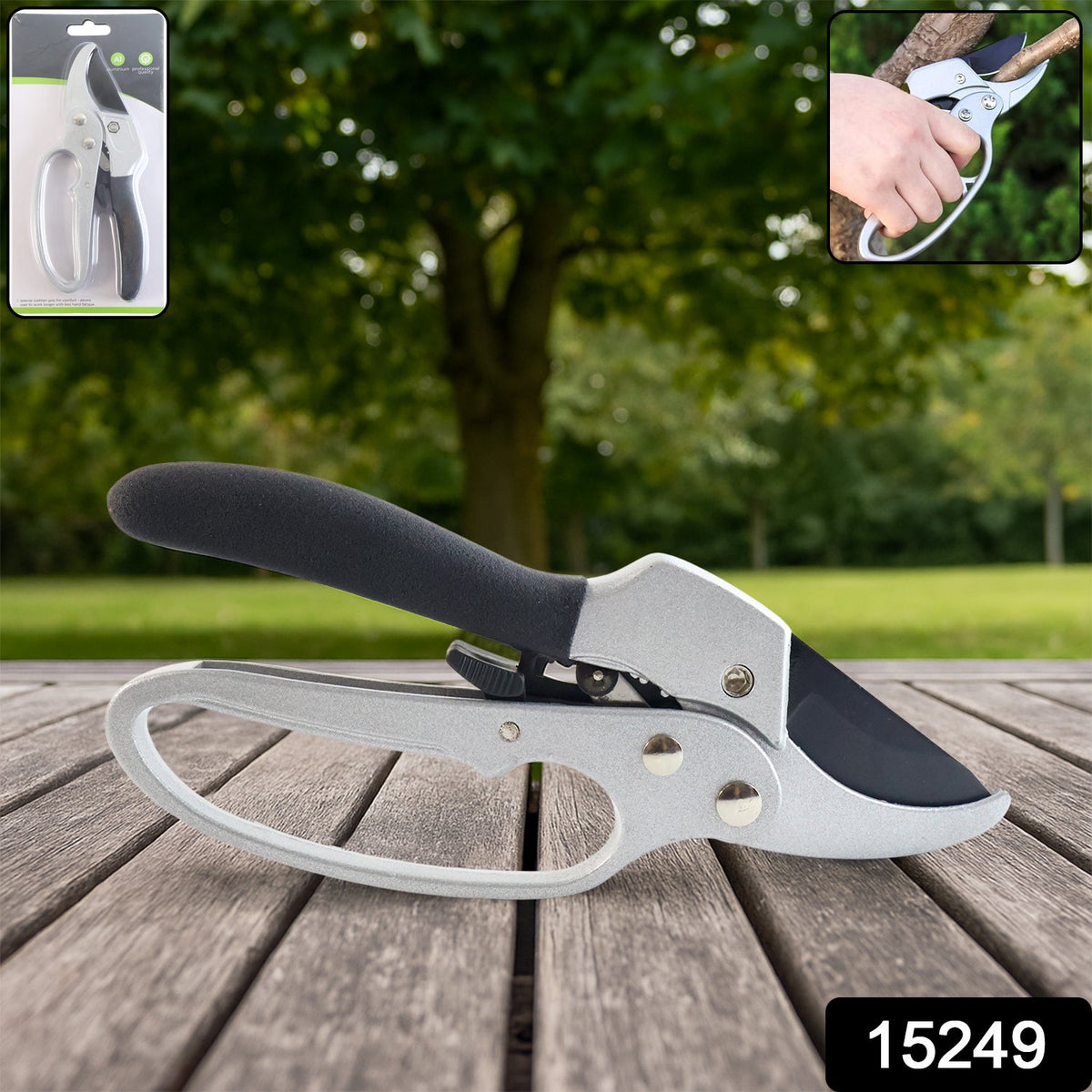 Silver and black pruning shears on a wooden surface with a blurred green background and packaging inset.